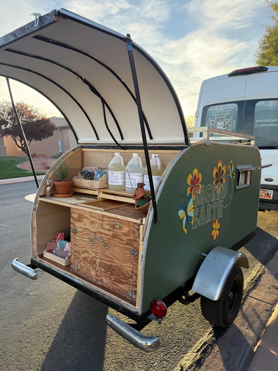 Gwen, the Sacred Earth mobile refillery trailer, open and stocked with zero-waste goods