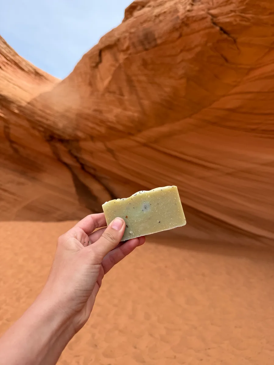 Handmade bar soap, sage green with texture, on red rock