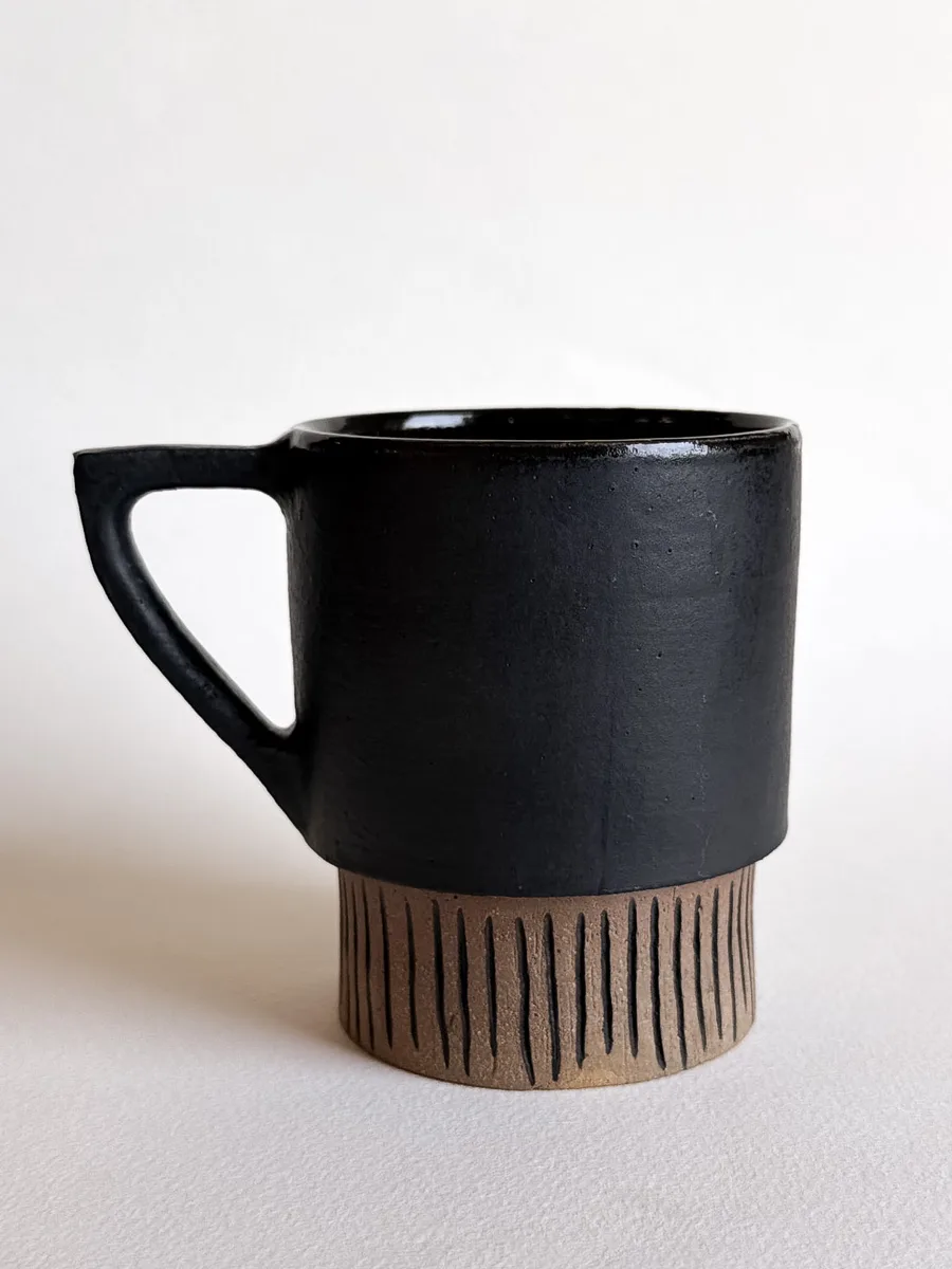 Matte black travel cup with a quarter lid