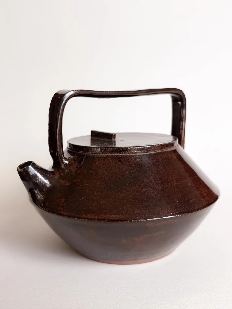 Stoneware teapot with a carved body