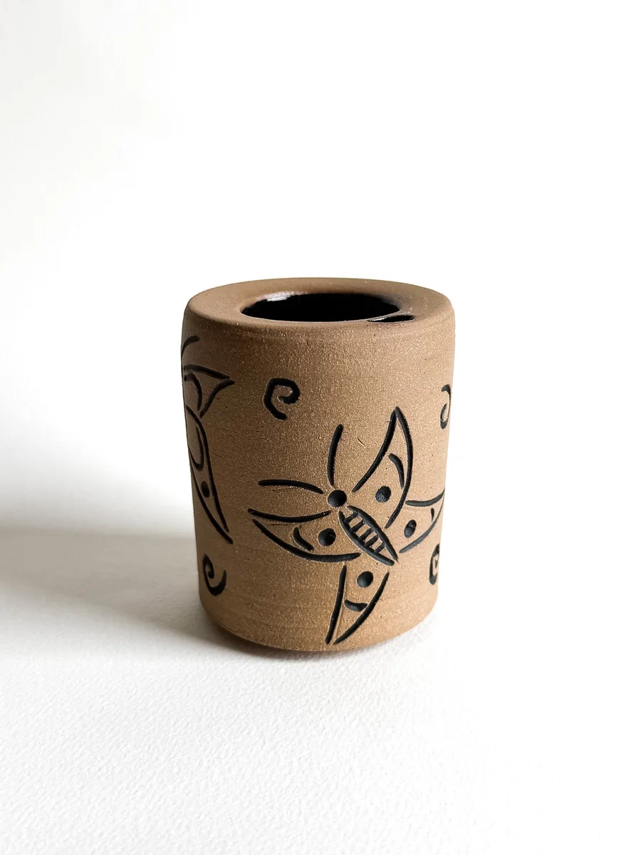 Travel cup with a hand-carved butterfly design