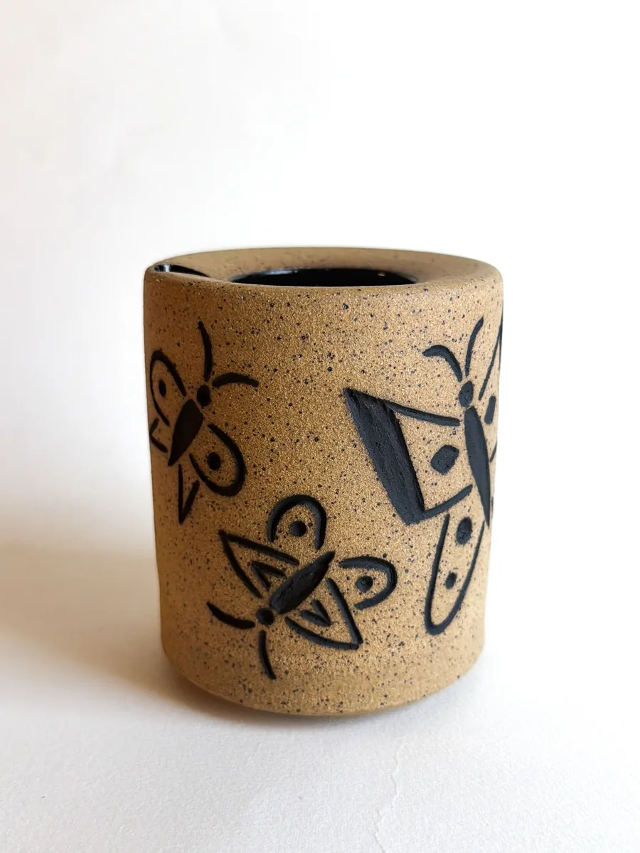 Travel cup with hand-carved butterflies