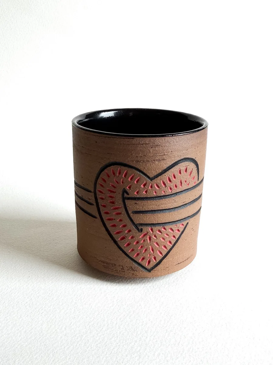Cup carved with a heart and dagger