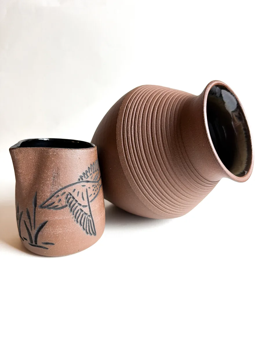 A stoneware pitcher in raw speckled clay