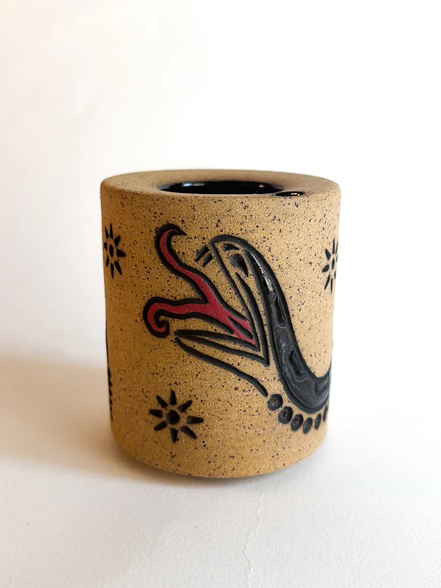 Travel cup with a second hand-carved snake design