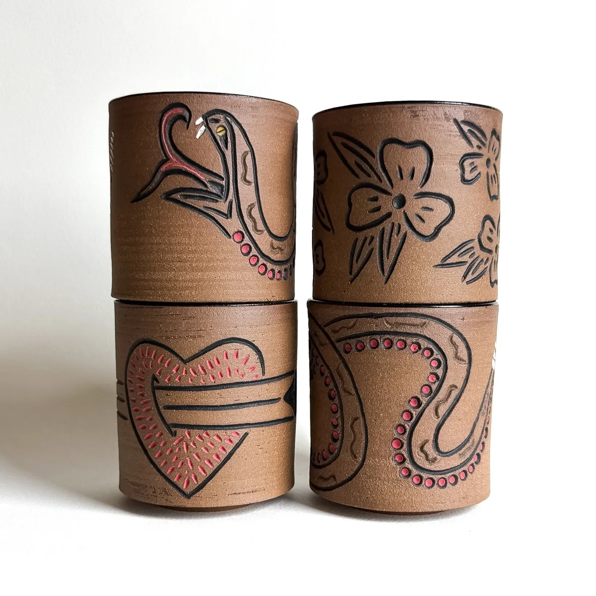 A group of hand-carved flash cups in raw clay