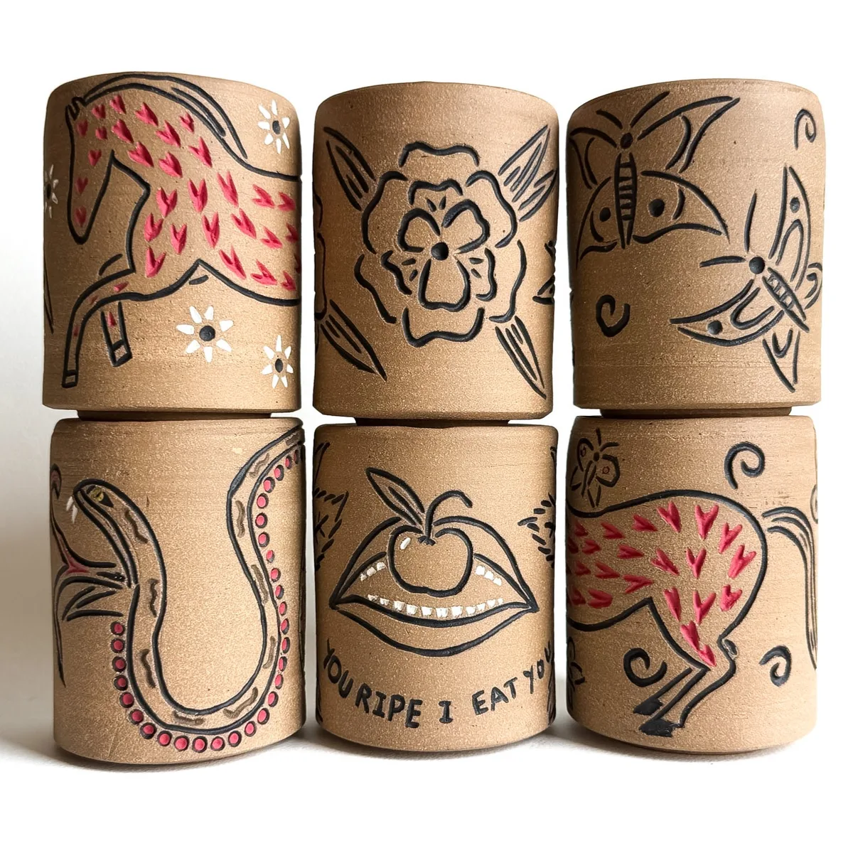 Carved travel cups with quarter lids, grouped together
