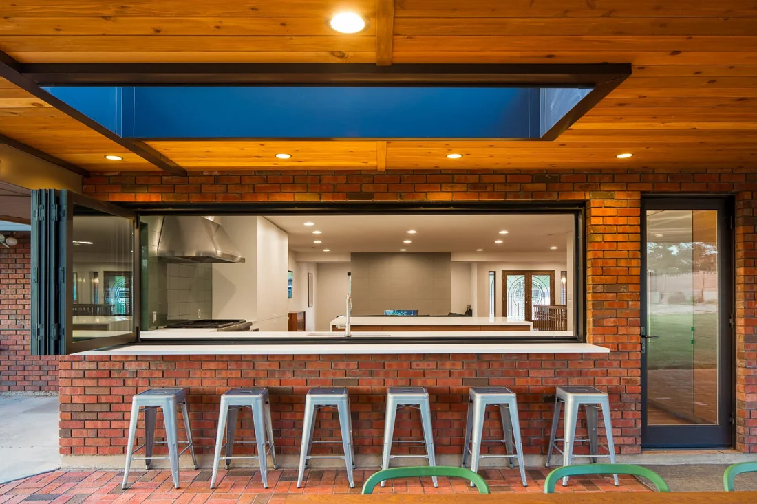 Open kitchen window connecting the home to a covered outdoor gathering area; Southern Utah residential remodeling
