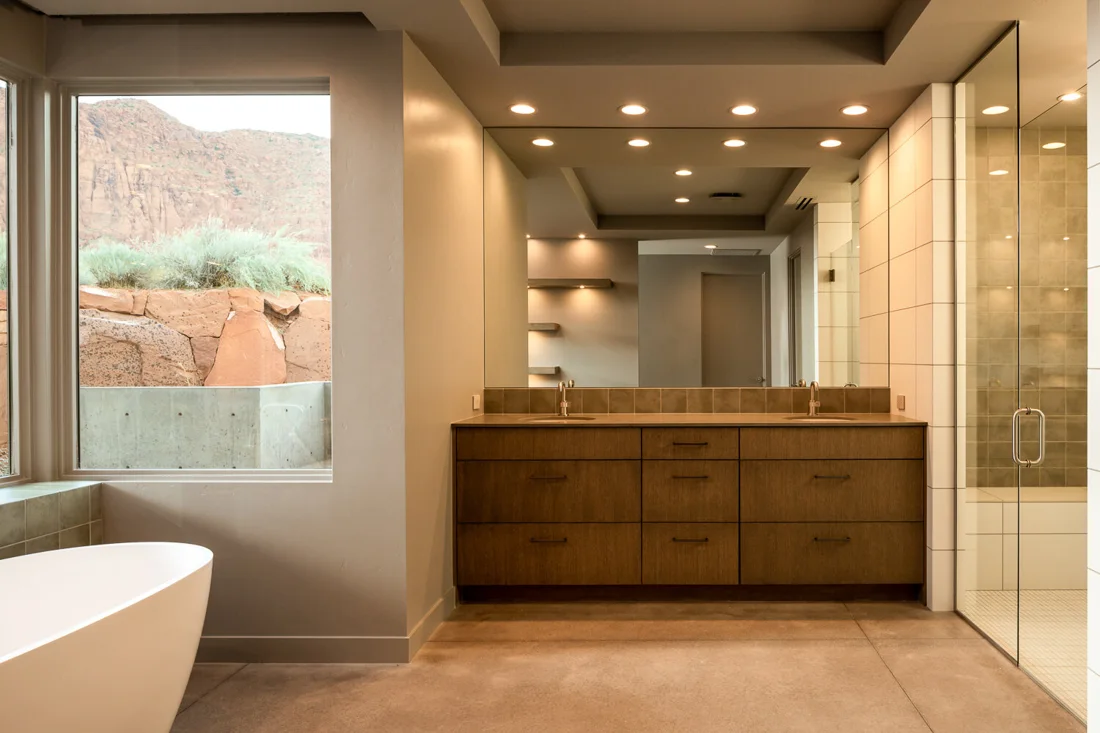 Bathroom with wood vanity and freestanding tub; Desert Concepts, Southern Utah residential design